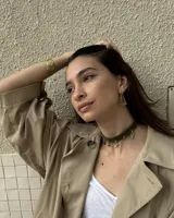 Gargantilla tipo choker de gamuza con dijes colgantes artesanales de metal y perlas naturales. Cuenta con tiras largas para atar y ajustar en la parte posterior.
