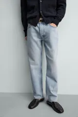 Pantalón de jean color celeste con efecto lavado, de corte recto y tiro medio, con diseño de cinco bolsillos y cierre frontal con botones.