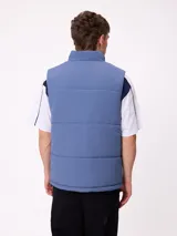 Chaleco reversible de nylon con diseño acolchado, cuello alto y cierre frontal. Cuenta con un bolsillo con cierre en el pecho y bolsillos laterales, además de una etiqueta con el logo de la marca.