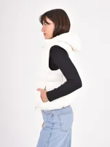 Chaleco acolchado de diseño puffer, con cierre frontal completo y cuello alto. Presenta un acabado liso en tono verde oliva.