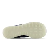 Championes New Balance 574 de hombre, color azul marino con detalles en gris, blanco y amarillo. Confeccionados en gamuza y malla, con logo "N" característico en los laterales y entresuela ENCAP.