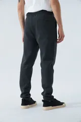 Pantalón deportivo de invierno, corte clásico con bolsillos laterales y cintura elástica con cordón ajustable. Presenta logo estampado y detalle en goma.