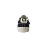 Championes urbanos Converse Star Player, color negro con detalles en blanco, confeccionados en lona, con logo de estrella y galón característico en los laterales.