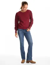 Buzo de tejido lurex marca Nanette, con cuello redondo y mangas largas con diseño plisado. Presenta puños ajustados con aplique de botones decorativos.