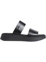Sandalias tipo slide Calvin Klein de cuero negro con doble tira y plataforma.