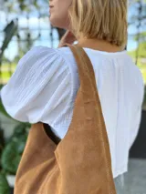 Bolso tipo tote bag color camel, confeccionado en cuero gamuzado.