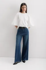 Pantalón de jean de corte ancho, color azul oscuro, con cintura alta y terminación desflecada.