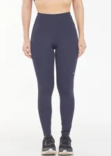 Calza deportiva larga de tiro alto, color azul, con bolsillos laterales funcionales y diseño anatómico de ajuste compresivo.
