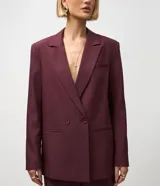 Blazer femenino color bordó, de corte oversized y caída recta. Presenta cierre traspasado con dos botones delanteros, mangas largas, cuello con solapa tradicional y bolsillos delanteros con acabado incorporado. Cuenta con forro interno.