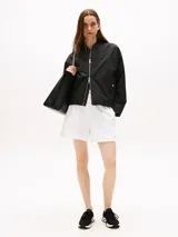 Zapatillas deportivas negras de corte bajo y estilo calcetín, con exterior de punto elástico. Cuentan con cordones, entresuela gruesa color crema y suela de goma negra. Presentan un pequeño logo de Tommy Hilfiger bordado en el lateral.