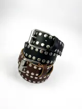 Cinturón negro de cuero vacuno con tachas plateadas y hebilla metálica.