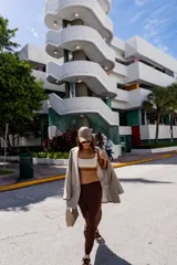 Top deportivo azul con contorno y tirantes blancos, banda inferior blanca con logo en rojo y borde inferior rojo.