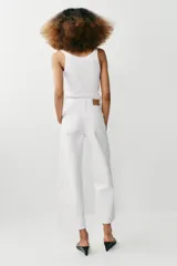 Jeans de tiro alto con diseño de pernera ancha y corte cropped, estilo culotte. Cuenta con cinco bolsillos y cierre frontal con cremallera y botón metálico.