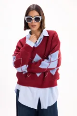 Sweater de punto con escote en V y calce relajado, con diseño de rombos en color bordó y celeste.