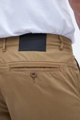 Pantalón cargo color marrón con bolsillos laterales y bolsillo cargo con solapa y botones.