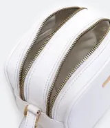 Bolso pequeño femenino de PU color blanco, con correa para cruzar, cierre de cremallera, divisorias internas y pompón decorativo.