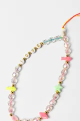 Correa para celular de cuentas de arcilla polimérica en colores vibrantes, con dijes de flores transparentes y cuentas con letras que forman la palabra LOVE.