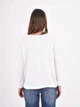 Remera de manga larga color negro, con cuello redondo y puños elásticos, de corte holgado.