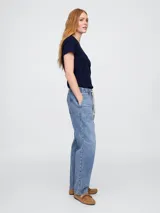 Jean de corte recto y tiro medio, con cintura elástica y cordón ajustable. Presenta un lavado medio con efecto desgastado y bolsillos frontales tipo cargo.