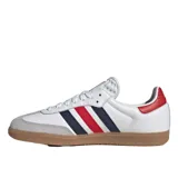 Championes Adidas modelo Samba de color blanco con detalles en rojo, azul marino y gris. Cuenta con diseño clásico de la marca, tres tiras laterales, puntera de gamuza gris y suela de goma.