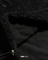 Canguro color marrón claro, con capucha y cordones ajustables, forrado con polar y reguladores en la cintura para ajustarlo.