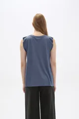 Remera blanca sin mangas con textura acanalada y corte holgado.