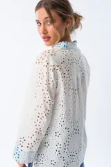 Camisa blanca con broderie y mangas largas con puños en color azul.