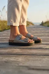 Sandalias de plataforma Oreiro con dos tiras ajustables con hebilla, detalle de tachas, base de corcho y suela de goma negra.