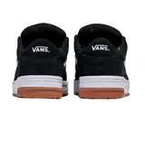 Championes Vans Hylane de estilo skate, color negro con la clásica franja lateral Sidestripe en blanco. Presentan cordones gruesos blancos, suela blanca gruesa de gran amortiguación y suela exterior de goma tipo waffle de color caramelo.