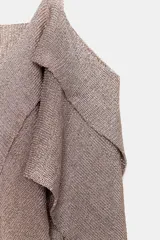 Top de punto con hilo metalizado en tono rosado/beige, escote pico, tirantes finos y bajo asimétrico con volados y nudo frontal.