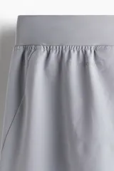 Short deportivo gris de corte estándar, confeccionado en tejido funcional DryMove™ con stretch en cuatro direcciones, cintura elástica con cordón ajustable, bolsillos laterales y aberturas laterales en el bajo.