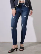Jean skinny de tiro alto color azul con desgaste.