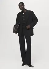 Pantalón de punto fino negro, de tiro medio y diseño recto con cintura elástica sin cierre.