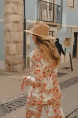 Blazer beige con estampado de unicornios alados y besos rojos.