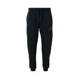 Pantalon de jogging Nike Jordan, confeccionado en tejido fleece color negro, con cintura elástica ajustable mediante cordón, puños elásticos en los tobillos y logo Jumpman bordado en color rojo en la pierna izquierda.
