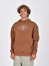 Buzo con capucha color marrón, de tejido liso, con bolsillo canguro frontal y puños y ruedo acanalados. Presenta un pequeño logo circular en la parte inferior del bolsillo.