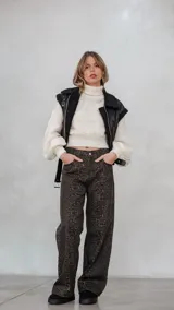 Chaleco de eco cuero negro con interior de corderito sintético, diseño oversize, cierre frontal y cinturón ajustable en el ruedo.