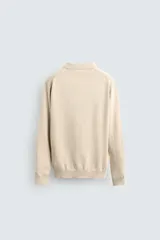 Polo de punto de corte regular fit, confeccionado en una mezcla de algodón. Presenta cuello solapa con abertura frontal, manga larga y acabados en rib en puños y bajo.