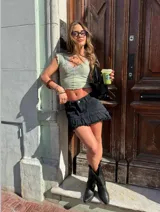 Remera corta color verde agua, con escote en V y detalle de puntilla blanca en el borde.