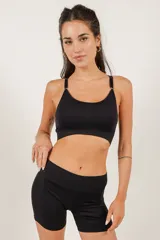 Top deportivo negro de microfibra sin costuras, con copas removibles y breteles regulables.