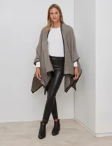 Ruana de tejido suave color azul oscuro, con vivos de ecocuero negro en los bordes.