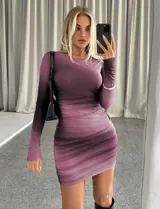Vestido corto ajustado de manga larga con diseño drapeado y efecto degradado en tonos violeta y púrpura.