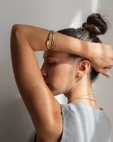 Brazalete rígido de bronce y alpaca maciza, con diseño orgánico irregular.