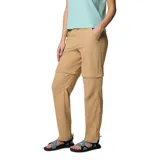 Pantalón de trekking convertible para mujer, color beige, con diseño desmontable que permite transformarlo en shorts. Cuenta con rodillas articuladas, múltiples bolsillos funcionales, presillas para cinturón y dobladillo ajustable.