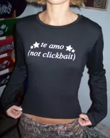 Remera negra de manga larga con cuello redondo y estampado frontal con la frase "te amo (not clickbait)" en color blanco.