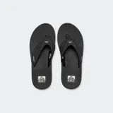 Sandalias Reef Fanning negras con suela marrón y cámara de aire visible.