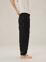 Pantalón barrel de lino y poliéster color negro, con costuras pespunteadas en contraste, bolsillos laterales amplios, bolsillos traseros y detalle de presilla con botón en los tobillos.