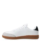 Championes urbanos Topper modelo Rocket, de color blanco con puntera de gamuza gris y suela de goma color caramelo. Presentan cierre por cordones, detalle de logo en la lengüeta y lateral, y un refuerzo negro en el talón.