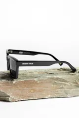 Lentes de sol negros de la marca Urban Haus, modelo Ares, con montura cuadrada y lentes oscuros.