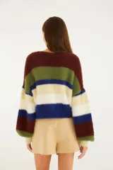 Cárdigan de tejido de punto con acabado afelpado y diseño de franjas horizontales multicolor, escote en V y cierre frontal de botones.